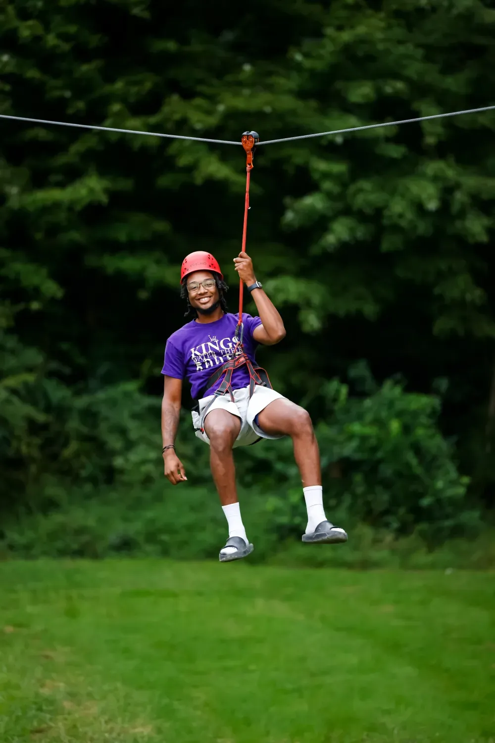 A Forever King on a zipline during a program intensive